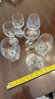 Group shot of all seven stemware pieces with measuring tape for scale