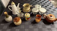 Overall view of all nine kitchenware pieces on table