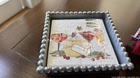 Metal beaded napkin holder with cocktail napkins