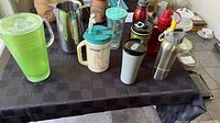 Group shot of all nine drinkware items displayed on table