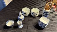 Overall group of porcelain pieces and utensil holder with spoons