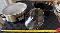 Slow cooker base, ceramic insert, glass lid with measuring tape for scale