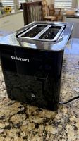 Front and side view showing Cuisinart branding, glossy finish, power button