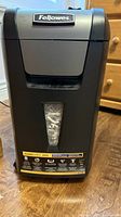 Front view showing Fellowes logo, clear waste-level window, model label