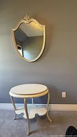 Full view of wall mirror above side table showing size relationship and finish