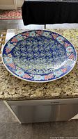 Top view of large blue multicolour ceramic platter on countertop