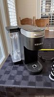 Front and side view of Keurig brewer with reservoir attached