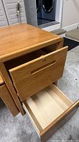 Top drawer open and bottom drawer partially open, shows interior and lock