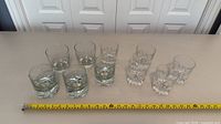 All ten tumblers arranged with tape measure for scale