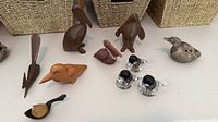 Group shot of all ten bird figurines displaying variety of materials