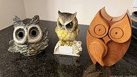 Frontal view of all three owl coin banks