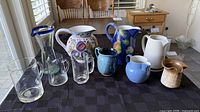 All ten pitchers and creamers displayed on table