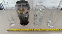 Four vases side by side with tape showing approximate heights and forms