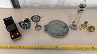 All seven items lined up with tape measure for scale