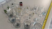 All pieces laid out showing variety of sizes and styles, tape for scale