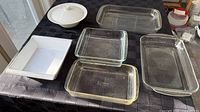 Overview of five dishes and one lid laid out on table