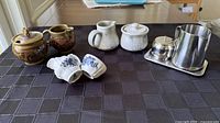 Group shot of all ceramic and stainless pieces on table