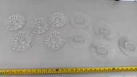 top view of all ten saucers showing two designs and ruler for scale