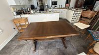 full view of rectangular dark brown oak dining table in kitchen setting