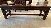 Full side view of solid wood bench showing overall design and proportions
