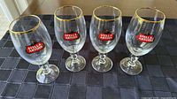 Four Stella Artois beer glasses front view