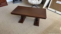 Full view of coffee table showing top and pedestal bases