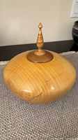 Overall view of bowl with lid and finial