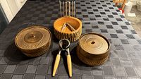Overview of two lidded bowls, bark bowl, nutcracker, six picks