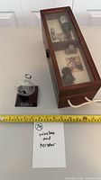 Box closed with aerator beside, measuring tape for scale