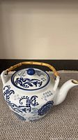 Full view of teapot front with lid and bamboo handle