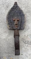 Front view of single Kota reliquary figure showing facial details, metal overlay and handle