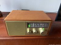 Front angled view showing wood cabinet and control layout