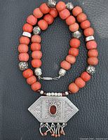 Full necklace showing bead strand and pendant