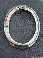 Oval sterling silver hinged bangle bracelet closed