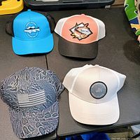 All four baseball hats arranged together