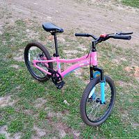 Full left-side view of Chipmunk pink and blue kids bicycle