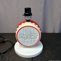 Front view of Coca-Cola bottle cap lamp on base with power cord