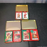 Open tins showing sealed decks inside