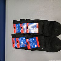 Six pairs black diabetic socks with packaging displayed