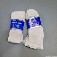 Two bundles of white diabetic socks in packaging