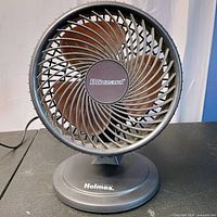 Front view of Holmes Blizzard fan showing grille, blades and logo