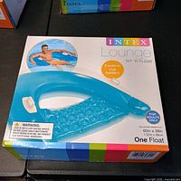 Front of sealed Intex Sit 'N Float lounge box showing product image and size