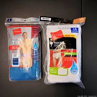 Front view of both sealed Hanes 7-pack briefs showing product names, colours, and size L