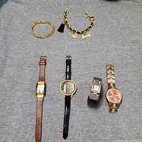 Group shot showing four watches and two bracelets