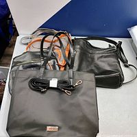 Group shot of all four handbags on table