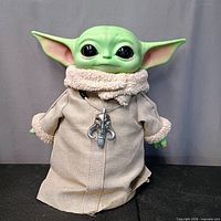 Front view of Grogu plush with robe