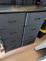 Front view showing eight fabric drawers in two columns beneath laminate top