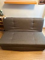 Front view of brown fabric sofa showing upholstery and overall condition