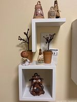 Group view of all seven ceramic items on wall shelves