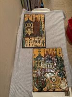 Front view of both glazed ceramic relief tiles showing cathedral scenes and glazing detail